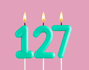 Green candle number 127 - Birthday card on pastel pink background