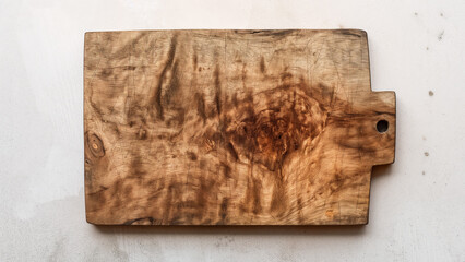 Fototapeta premium Rustic wooden cutting board with natural grain texture on white background, perfect for food styling and kitchen themes.