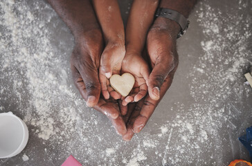 Hands, family and kid baking with heart cookie, father and love in kitchen with learning and flour. Home, dough above and cooking with teaching, youth development and support together with dessert
