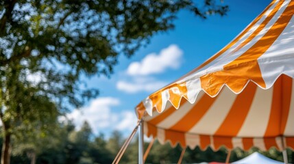 The image depicts an orange and white striped tent pitched outdoors with lush green trees and a clear blue sky in the background, creating a cheerful and inviting atmosphere.