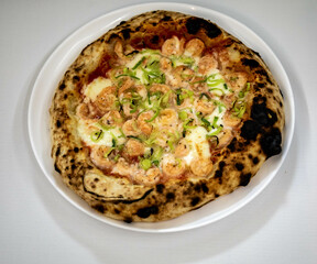 Rustic artisanal shrimp pizza with catupiry cheese and leeks