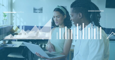 Analyzing data on laptop, business colleagues with financial charts image