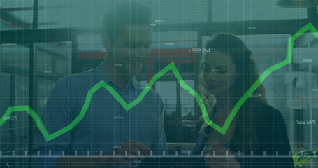 Financial data graph image over business people discussing in office