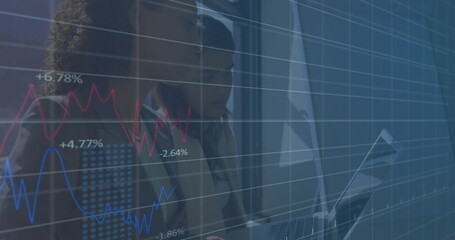 Financial data charts image over business people working on laptop