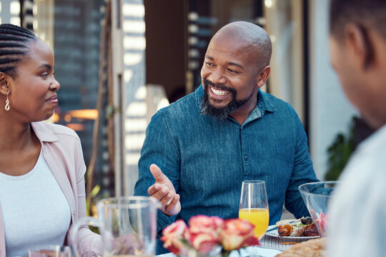 Black family, lunch and people with conversation by home for love, event and eating together at reunion. African man, happy and communication in backyard at table for meal, nutrition and celebration