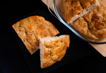 food concept homemade focaccia on black background with copy space