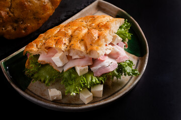 Food concept homemade focaccia, focaccia feta cheese and bacon on black background with copy space