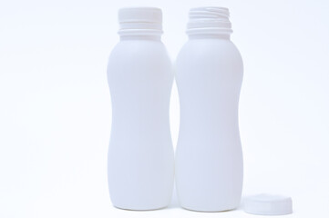 White plastic bottle with cap on a white background.