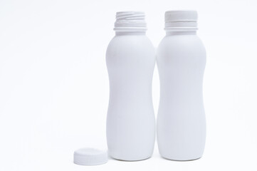 White plastic bottle with cap on a white background.