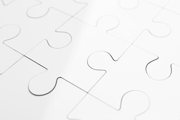 White puzzle as background, closeup. Intellectual game