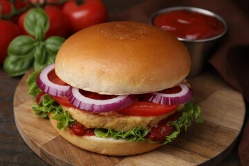 Delicious vegan burger with chickpea cutlet on wooden table, closeup