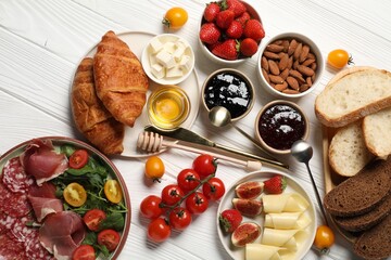 Different tasty food served for brunch on white wooden table, flat lay