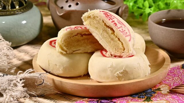 Mung bean cake on the plate,the Chinese words on the moon cake is 'mung bean cake', not a logo or trademark.