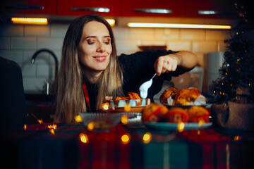 Woman Putting a spoonful of sour cream on the Cabbage Rolls. Housewife preparing a traditional Xmas...