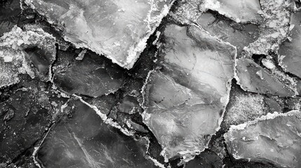 Obraz premium Gray Ice Texture. A close-up of ice with cracks and textures in various shades of gray.