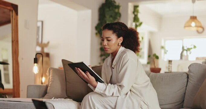 Woman, remote work and scroll with tablet, online and email as freelance copywriter in living room. Female person, busy and reading with technology on deadline, project and article for agency in home