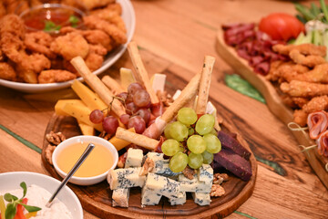 Plate with grapes, smoked meat and cheese with mold, Romania 2024, Romania 2024