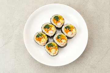 Korean Rolled Gimbap, made of rice, cucumber, tuna, carrot, sausage, crab stick and wrapped with seaweed laver. 
