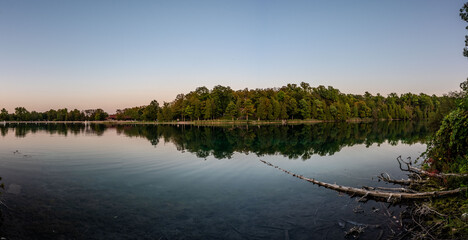 Captivating sunset at Green Lakes Park in Syracuse, NY, showcasing crystal clear waters, lush forests, and serene reflections. Ideal for nature lovers and peaceful getaways.