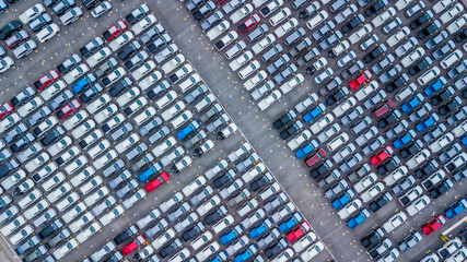 Aerial view new cars lined up in the port for import and export, Top view of new cars lined up automobile factory global logistic import export, New cars logistic to dealership for sale.