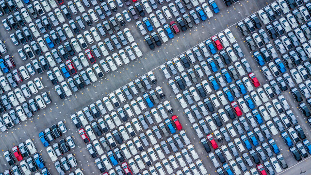 Aerial view new cars lined up in the port for import and export, Top view of new cars lined up automobile factory global logistic import export, New cars logistic to dealership for sale.