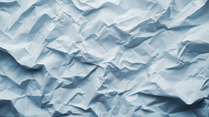 Fototapeta premium Crumpled blue paper texture background showcases intricate folds and shadows in natural light