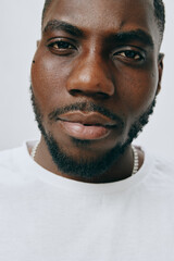 Obraz premium Close up portrait of a confident young man with a fresh look, showcasing smooth skin and stylish facial hair, set against a neutral background