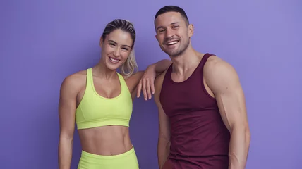 Smiling Fitness Instructors Posing Against a Vibrant Purple Background