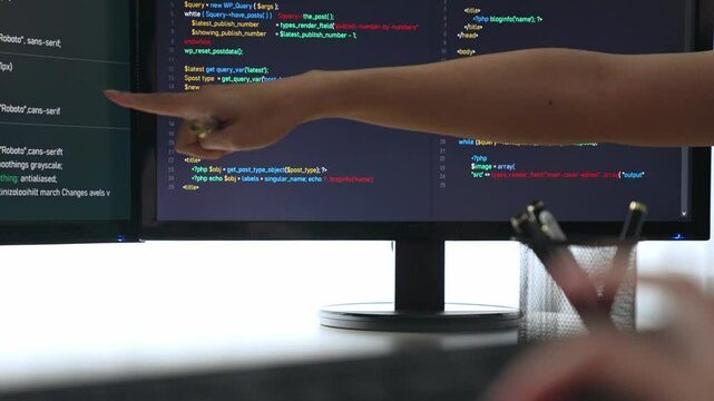 Slow motion closeup hand, back end software developer engineer for computer programming working together on debugging writing computing code, solving complex algorithms display on monitor. Burgeoning