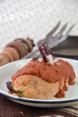 Authentic mexican food Chile Capeado, stuffed and breaded poblano pepper with spicy adobo sauce.