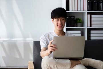 Young Boy Studying Online at Home with Laptop, Engaged in Virtual Learning, Remote Education, and Digital Classroom Activities