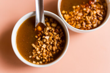 A mini bowl of sauce dip of Vietnamese cuisine, taste sweet and sprinkle with peanuts for eating with nem nuong vietnamese pork sausage