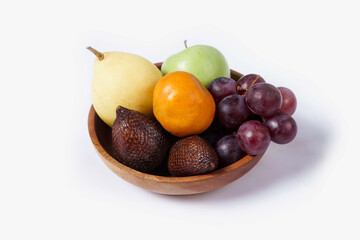 Assortment of exotic fruits isolated on white background. Close up of heap of fruit. Concept of healthy eating and dieting lifestyle. 