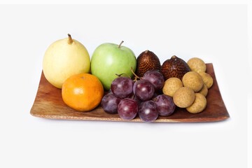 Assortment of exotic fruits isolated on white background. Close up of heap of fruit. Concept of healthy eating and dieting lifestyle. 