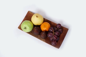 Assortment of exotic fruits isolated on white background. Close up of heap of fruit. Concept of healthy eating and dieting lifestyle. 