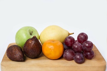 Assortment of exotic fruits isolated on white background. Close up of heap of fruit. Concept of healthy eating and dieting lifestyle. 