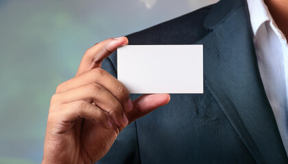 Obraz premium man in suit holding blank white business card mockup