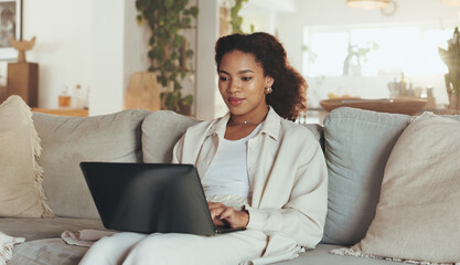 Fototapeta premium Laptop, remote work and website with business woman on sofa in living room of home for research. Computer, planning and typing with African employee in apartment for administration or information