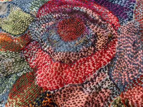 Closeup of kantha hand embroidered on patchwork flower