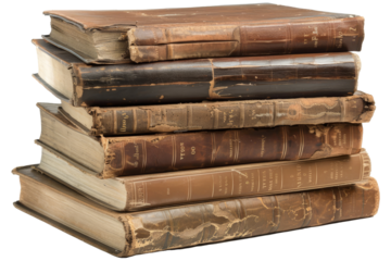 A collection of well-worn vintage books stacked neatly on a surface, showcasing intricate bindings and varied colors in a cozy reading corner