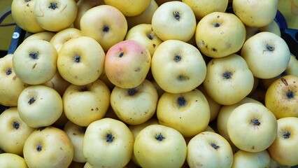 Fresh Yellow Apples in a Market Stall