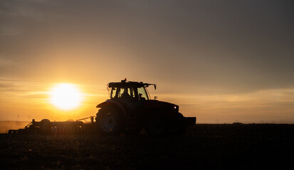 Fototapeta premium Tractor preparing the land for a new crop planting