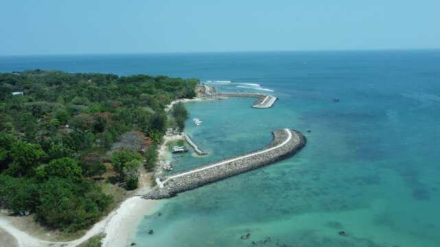 Aerial photo of Tanjung Lesung beach resort landmark, with blue sky and beautiful blue sea. Aerial drone of La Lassa Beach Club during the day.