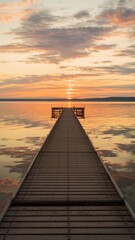 Obraz premium Wooden pier extending into calm water at sunset with colorful clouds reflecting on the lake. Tranquil landscape and nature concept. Design for posters, banners, and wallpapers