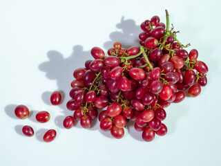 Fresh Red Grapes with Shadows on White Background