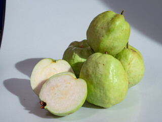 Fresh Green Guavas on White Surface