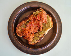 A tuna and bean mix with BBQ sauce on toasted cob bread with basil pesto.