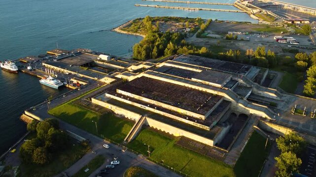 Drone footage of Scenic aerial view of Linnahall opera house theather in tallin at sunset, showcasing the soviet architecture and surrounding waterfront bay area landscape