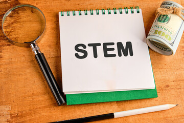 STEM word and symbols in a notebook on a papyrus background