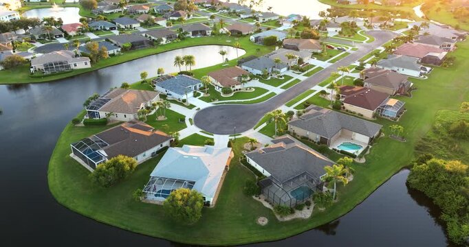 Cul de sac street dead end at sunset and private residential houses in rural suburban sprawl area in North Port, Florida. Upscale suburban homes with large waterfront backyards